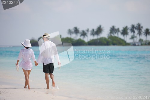 Image of happy young couple have fun on beach