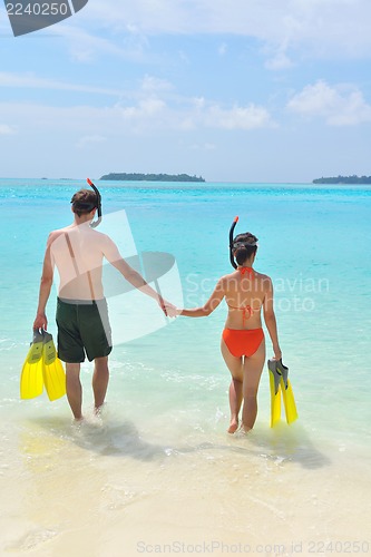 Image of happy young couple have fun on beach