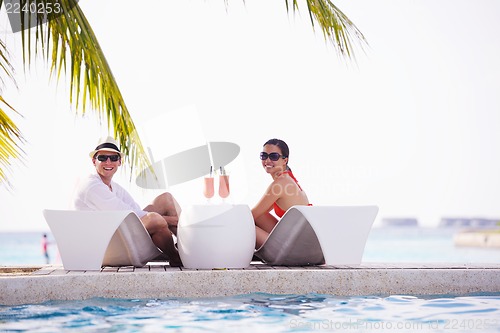 Image of happy young couple have fun on beach
