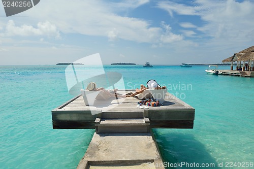 Image of happy young couple have fun on beach