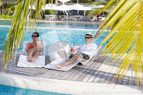 Image of happy young couple have fun on beach