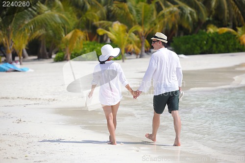 Image of happy young couple have fun on beach