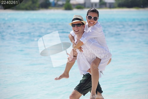 Image of happy young couple have fun on beach