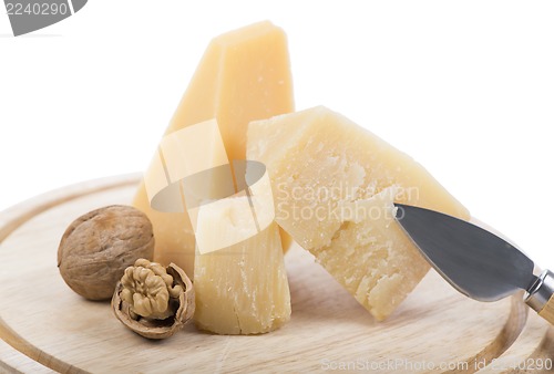 Image of Nuts and cheese on wooden board.