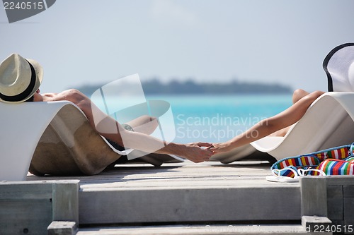 Image of happy young couple have fun on beach