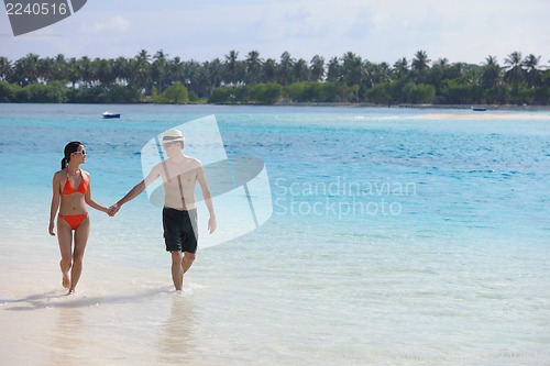 Image of happy young couple have fun on beach