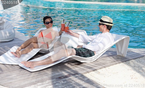 Image of happy young couple have fun on beach