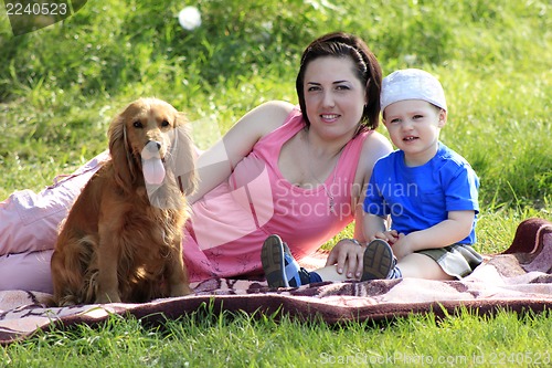 Image of Mother, child and dog on picnic