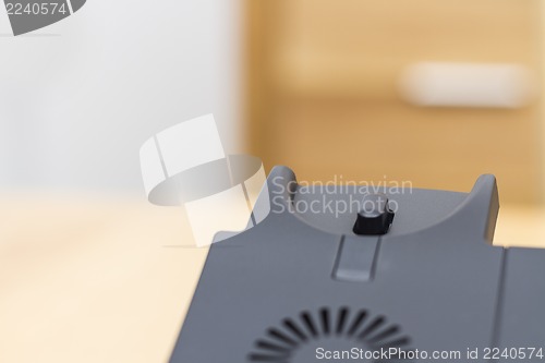 Image of detail of telephone on wooden desk