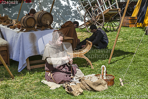 Image of Medieval Young Woman Spinning Wool