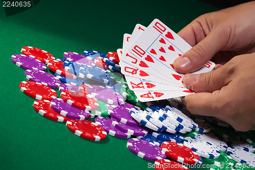 Image of Colorful poker chips and royal flush