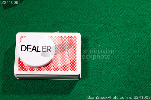 Image of Poker cards with dealer chip
