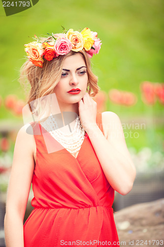 Image of beautiful woman portrait outdoor with colorful flowers