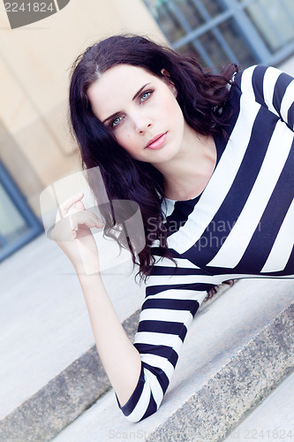 Image of beautiful woman in sexy dress on stairs summertime