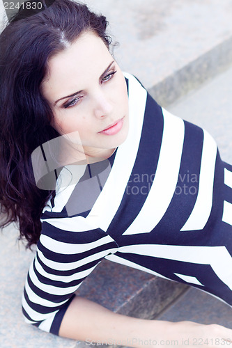 Image of beautiful woman in sexy dress on stairs summertime