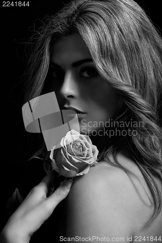 Image of beautiful woman and flower in monochrome