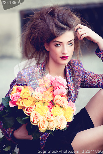 Image of attractive young woman with pink roses
