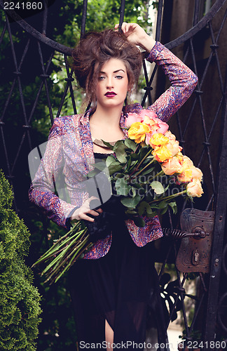 Image of attractive young woman with pink roses