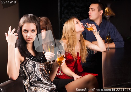 Image of young friends relaxing in a bar