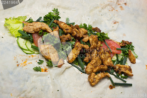 Image of Ingredients for shawarma laid on dough