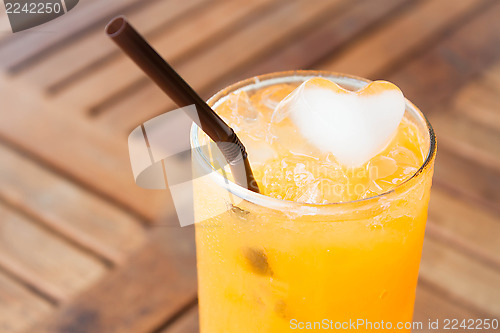 Image of Heart cube ice of fresh orange juice 