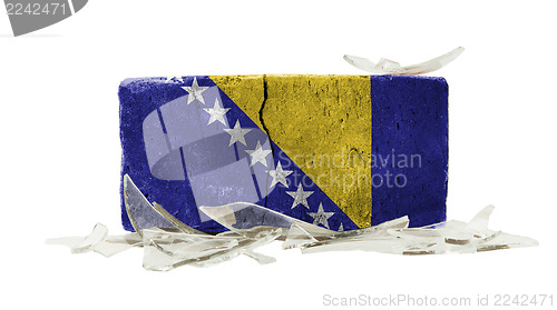 Image of Brick with broken glass, violence concept