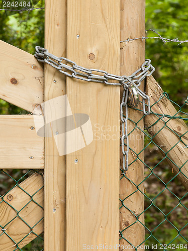 Image of Chain hanging on a abandoned gate