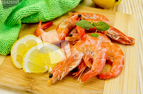 Image of Shrimps on board with lemon