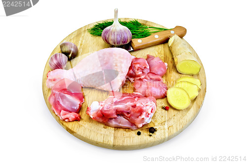 Image of Chicken leg cut on a round board