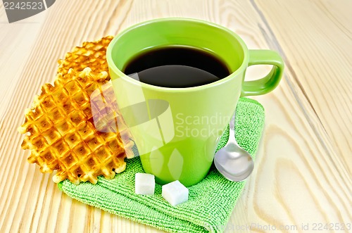 Image of Wafers are round with a green mug and sugar