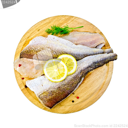 Image of Fillet of codfish on a round board with dill
