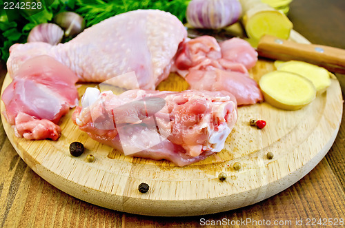 Image of Chicken leg cut on a wooden board