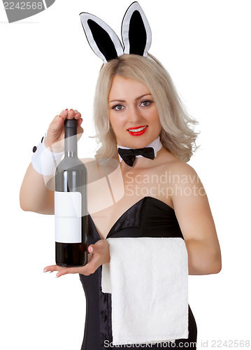 Image of Waitress in bunny suit shows a bottle of wine