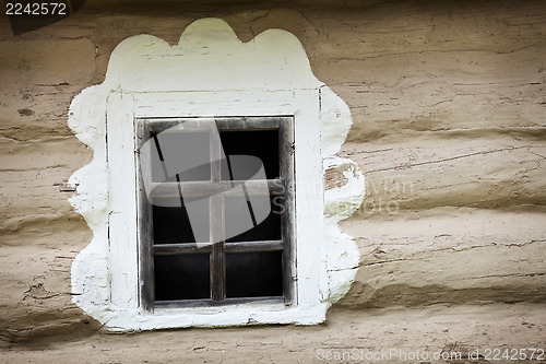 Image of Window of ancient Ukrainian hut. Clay covered wall