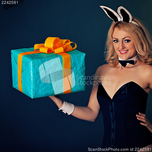 Image of Young rabbit girl with biggest gift on hand