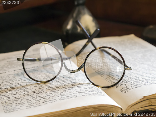 Image of Old glasses on antique book