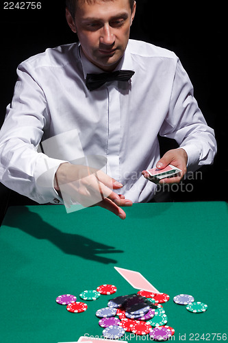 Image of Gentleman in white shirt, playing cards