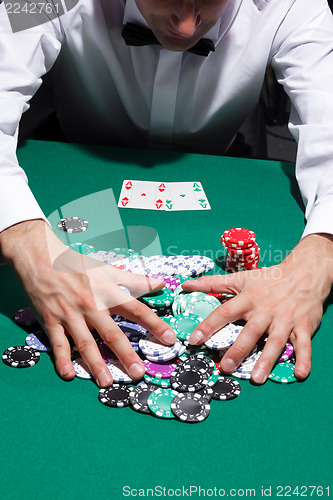 Image of Gentleman in white shirt, playing cards