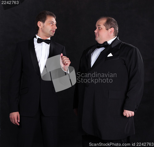 Image of Two stylish businessman in tuxedos