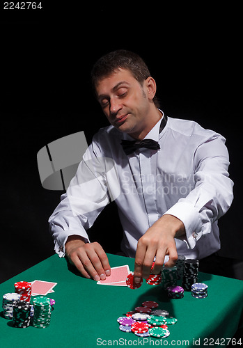 Image of Gentleman in white shirt, playing cards