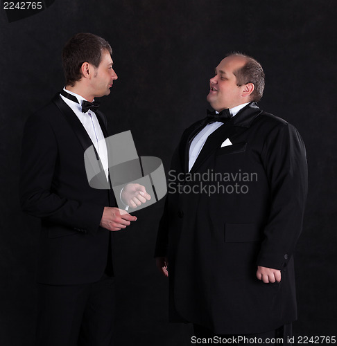 Image of Two stylish businessman in tuxedos