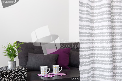 Image of Sofa with bright cushions in a living room