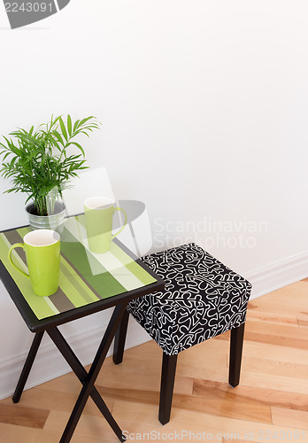 Image of Little table with bright green cups