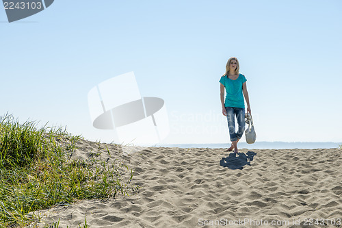 Image of Young Woman Standing On Beach