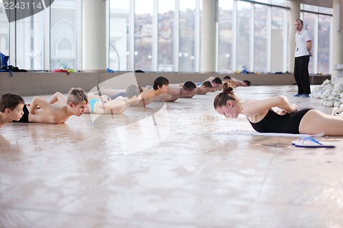 Image of happy children group  at swimming pool