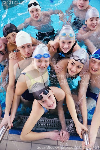 Image of happy teen group  at swimming pool