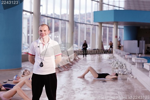 Image of happy children group  at swimming pool