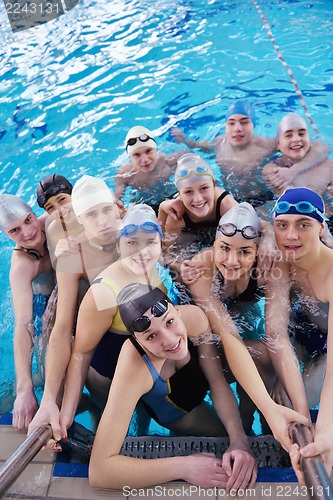 Image of happy teen group  at swimming pool