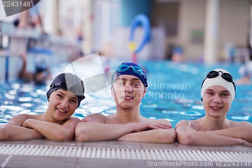 Image of happy teen group  at swimming pool