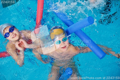 Image of happy children group  at swimming pool